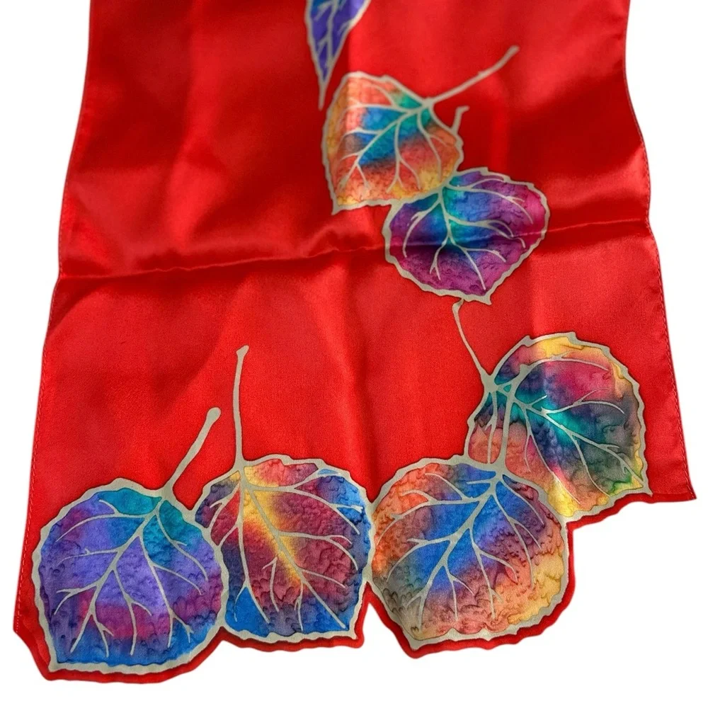 Kriska hand painted silk scarf. Red with multicolored leaves and cutouts. NWOT